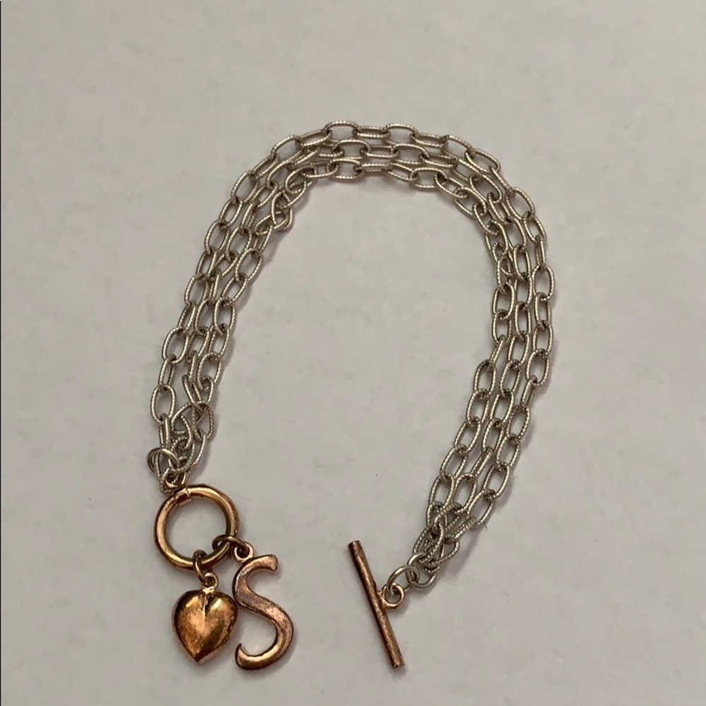 Silver bracelet with gold tone toggle